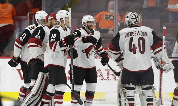 Arizona Coyotes' Alex Goligoski, center right, celebrates the win with Scott Wedgewood, right, foll...