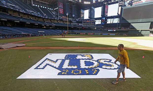 The grounds crew prepares the field before Game 3 of baseball's National League Division Series bet...
