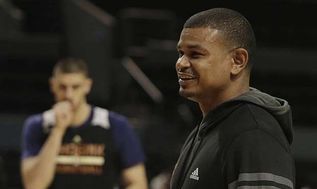 Phoenix Suns head coach Earl Watson walks on the court past player Alex Len during a training sessi...