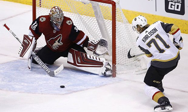 Arizona Coyotes goalie Antti Raanta (32) slides over the make a save on a shot by Vegas Golden Knig...