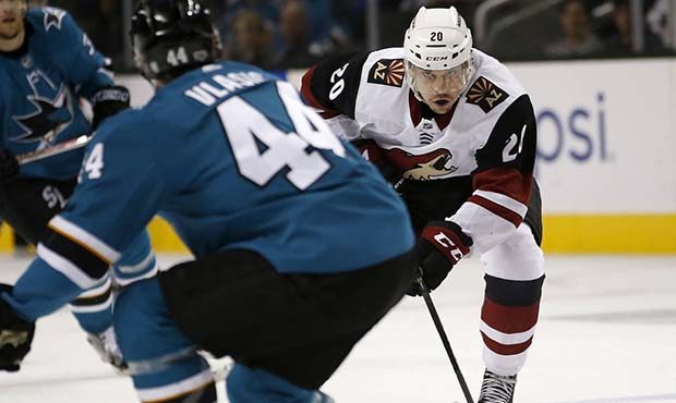 Arizona Coyotes center Dylan Strome (20) advances the puck past San Jose Sharks defenseman Marc-Edo...