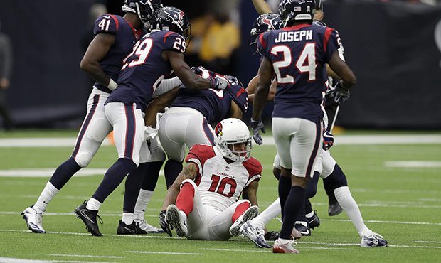Houston Texans defenders celebrate defensive back Eddie Pleasant's interception over Arizona Cardin...