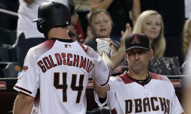 Arizona Diamondbacks Paul Goldschmidt (44) greets manager Torey Lovullo after scoring on a base hit...