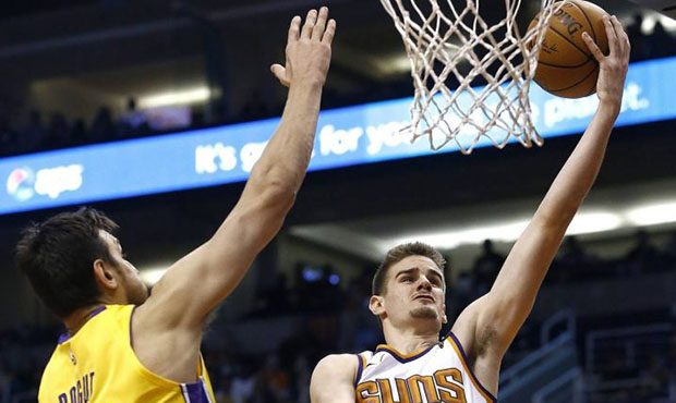 Phoenix Suns forward Dragan Bender, right, drives past Los Angeles Lakers center Andrew Bogut (66) ...