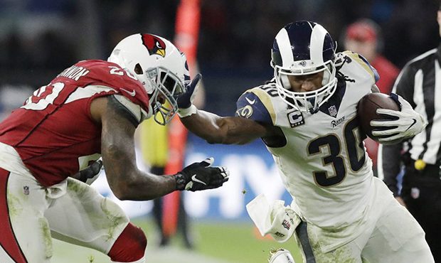 Los Angeles Rams running back Todd Gurley (30) holds off Arizona Cardinals inside linebacker Deone ...
