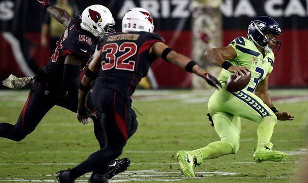 Seattle Seahawks quarterback Russell Wilson (3) scrambles as Arizona Cardinals free safety Tyrann M...