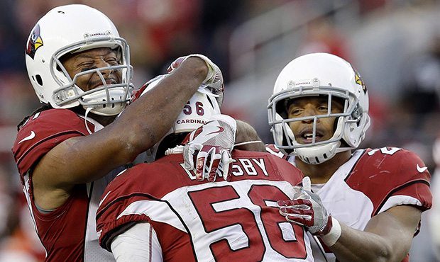 Arizona Cardinals inside linebacker Karlos Dansby (56) celebrates with Larry Fitzgerald, left, and ...