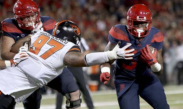Oregon State defensive tackle Kalani Vakameilalo (97) reaches for Arizona running back Zach Green (...