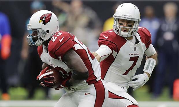 Arizona Cardinals quarterback Blaine Gabbert (7) hands off to running back Adrian Peterson (23) dur...