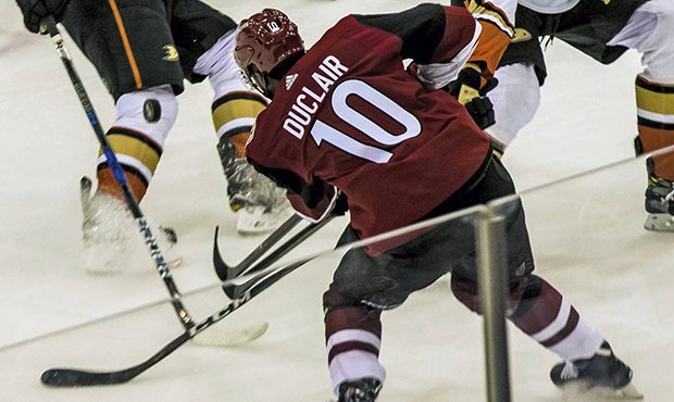 Arizona Coyotes left wing Anthony Duclair (10) passes the puck against Anaheim Ducks defenders duri...
