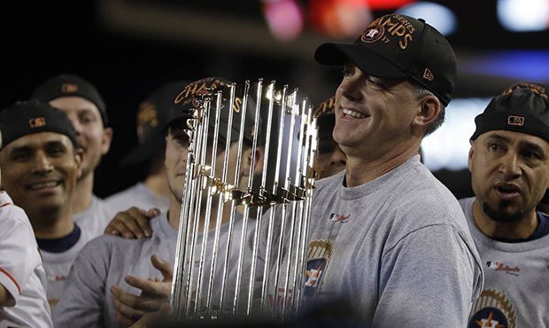Houston Astros manager A.J. Hinch holds the championship trophy after Game 7 of baseball's World Se...