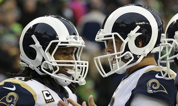 Los Angeles Rams running back Todd Gurley, left, is greeted by quarterback Jared Goff, right, after...