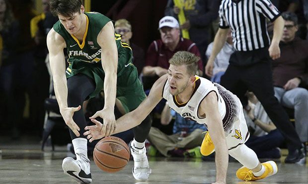 San Francisco center Erik Poulsen, left, and Arizona State guard Kodi Justice (44) battle for a loo...