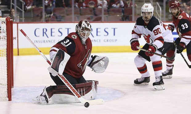 Arizona Coyotes goalie Scott Wedgewood (31) deflects a shot as New Jersey Devils' Marcus Johansson ...