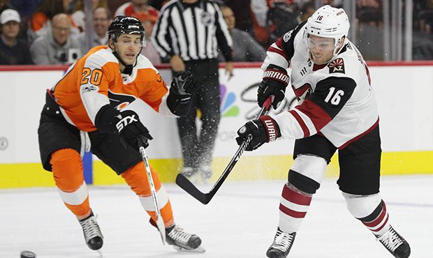 Arizona Coyotes' Max Domi, right, shoots the puck past Philadelphia Flyers' Taylor Leier, left, dur...