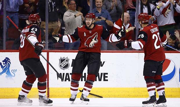 Arizona Coyotes center Derek Stepan, middle, celebrates his goal against the Dallas Stars with Coyo...