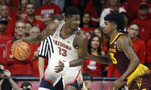 Arizona forward Deandre Ayton (13) works to the basket as Arizona State's Romello White defends dur...