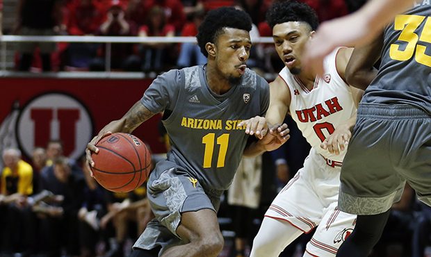 Arizona State guard Shannon Evans II (11) drives around Utah guard Sedrick Barefield (0) in the fir...