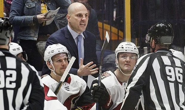 Arizona Coyotes coach Rick Tocchet, center, argues a call during the third period of the team's NHL...