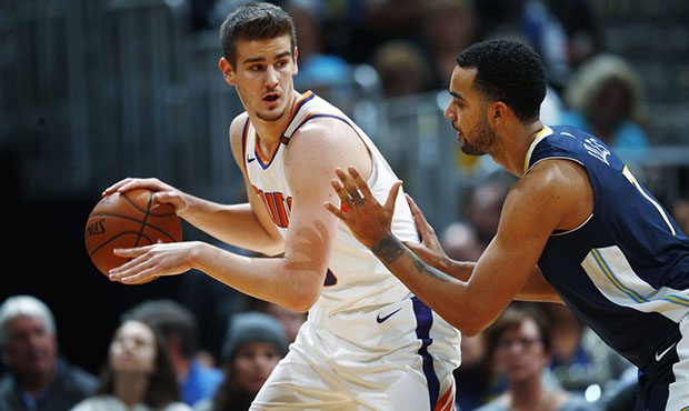 Phoenix Suns forward Dragan Bender, left, looks to pass the ball as Denver Nuggets forward Trey Lyl...