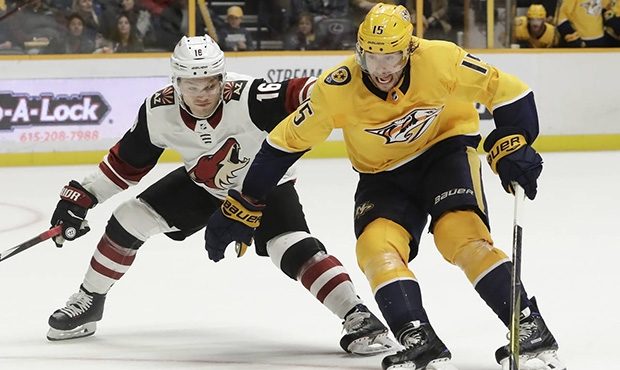 Nashville Predators right wing Craig Smith (15) is defended by Arizona Coyotes' Max Domi (16) in ov...