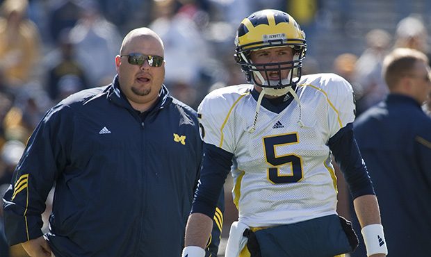 Michigan quarterbacks coach Rod Smith, left, stands with freshman quarterback Tate Forcier (5) in t...