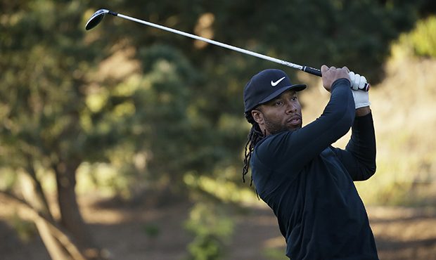 Arizona Cardnals NFL football player Larry Fitzgerald follows his drive from the first tee of the S...