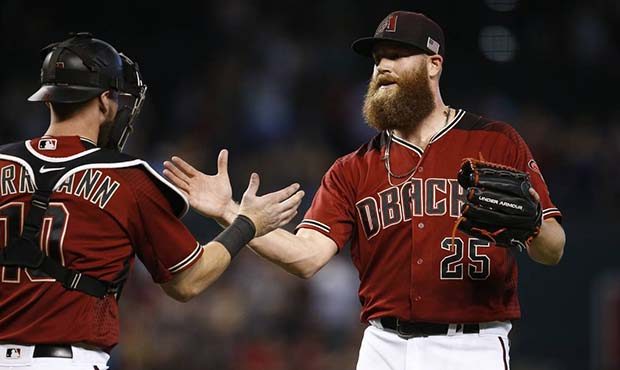 Arizona Diamondbacks' Archie Bradley (25) slaps hands with catcher Chris Hermann, left, after the f...