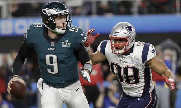 Philadelphia Eagles' Nick Foles (9) scrambles from New England Patriots' Trey Flowers during the fi...