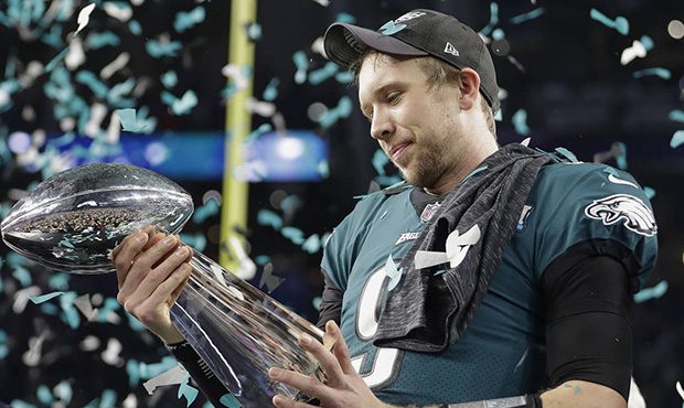 Philadelphia Eagles' Nick Foles holds up the Vince Lombardi Trophy after the NFL Super Bowl 52 foot...