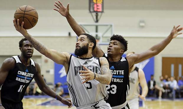 Orlando Magic's Josh Gray (5) goes up for a shot in front of Charlotte Hornets' Tyrell Corbin (23) ...