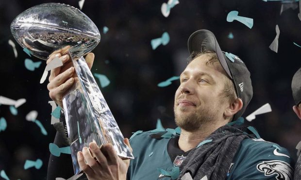 Philadelphia Eagles' Nick Foles holds up the Vince Lombardi Trophy after the NFL Super Bowl 52 foot...