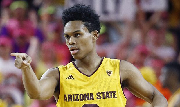 Arizona State guard Tra Holder (0) points to a teammate after scoring during the first half of an N...