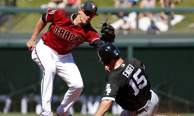 Arizona Diamondbacks' Nick Ahmed, left, tags out Chicago White Sox's Adam Engel (15) on a steal-att...