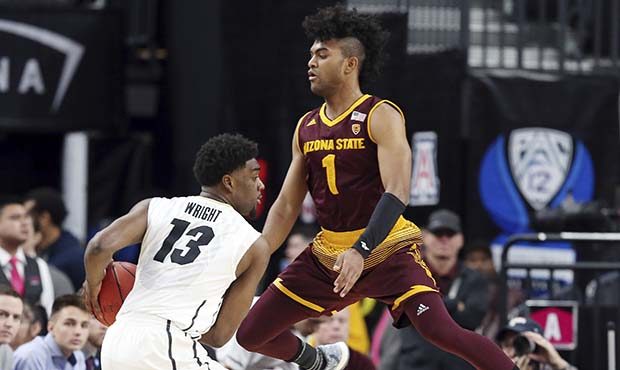 Arizona State's Remy Martin leaps as he defends against Colorado's Namon Wright during the first ha...