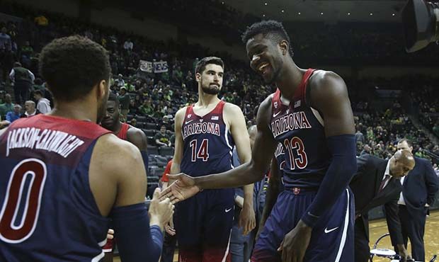 Arizona's Parker Jackson-Cartwright, left, Dusan Ristic (14) and DeAndre Ayton celebrate during tea...
