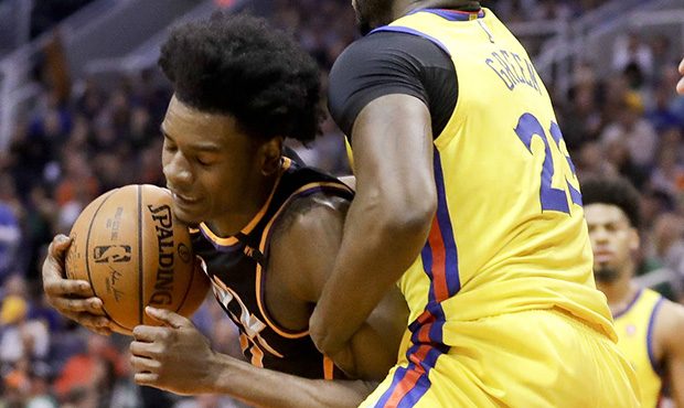 Golden State Warriors forward Draymond Green, right, fouls Phoenix Suns guard Josh Jackson during t...