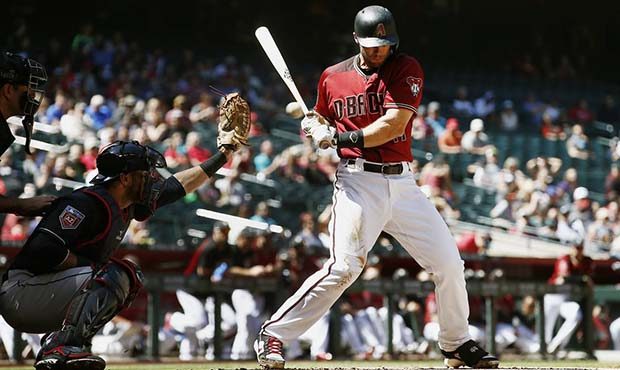 Arizona Diamondbacks first baseman Paul Goldschmidt, right, gets brushed back by a pitch as Clevela...