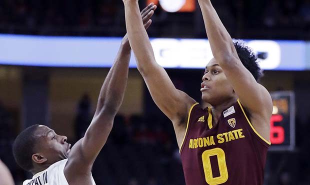 Arizona State's Tra Holder shoots covered by Colorado's McKinley Wright IV during the first half of...
