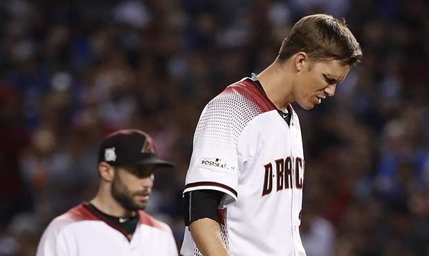 Arizona Diamondbacks starting pitcher Zack Greinke (21) looks down after giving up a base hit again...