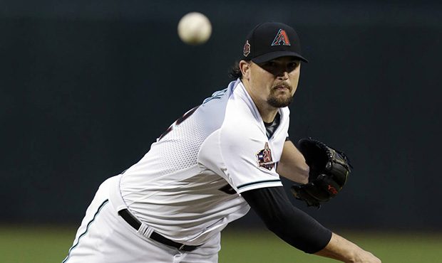 Arizona Diamondbacks pitcher Zack Godley throws in the first inning during a baseball game against ...