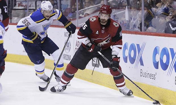 Arizona Coyotes center Brad Richardson (15) shields St. Louis Blues defenseman Colton Parayko from ...