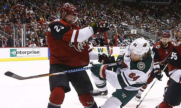 Minnesota Wild right wing Mikael Granlund (64) gets off a shot between Arizona Coyotes defenseman O...