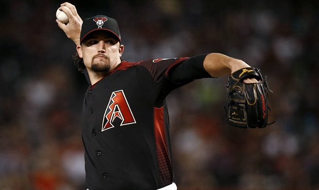 Arizona Diamondbacks starting pitcher Zack Godley throws to a San Diego Padres batter during the fi...