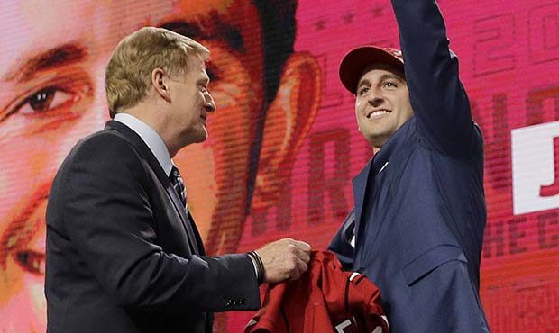 UCLA's Josh Rosen, right, gestures next to commissioner Roger Goodell after being selected by the A...