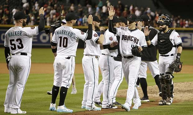 Arizona Diamondbacks starting pitcher Patrick Corbin (46) celebrates with teammates after pitching ...