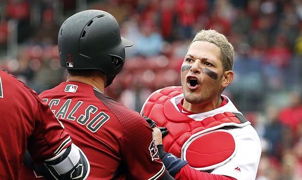 St. Louis Cardinals catcher Yadier Molina, right, is held back by Arizona Diamondbacks' Daniel Desc...