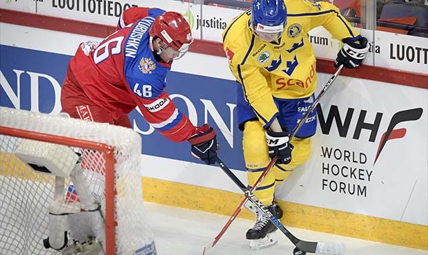Ilya Lyubushkin, left, of Russia and Carl Klingberg of Sweden fight for the puck during the Euro Ho...
