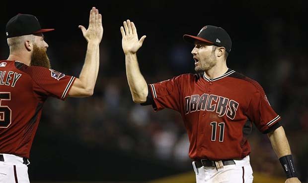 Arizona Diamondbacks center fielder A.J. Pollock (11) celebrates with relief pitcher Archie Bradley...