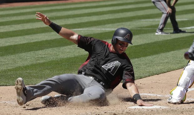 Arizona Diamondbacks' David Peralta scores a run against the Oakland Athletics during the sixth inn...
